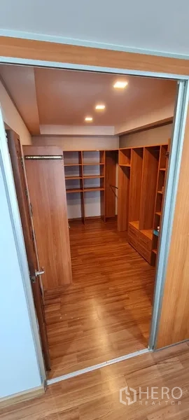 Home Office for rent - Entrance to a walk‑in closet with wooden shelving