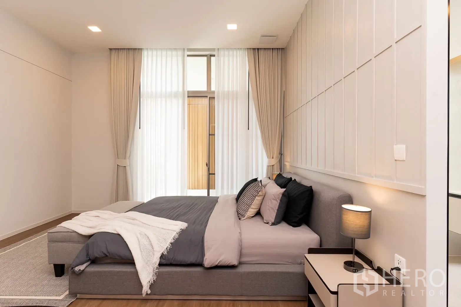 Detached House for rent in Saphan Sung, Bangkok - Serene master bedroom with tall sheer curtains, accent wall and bedside lamps