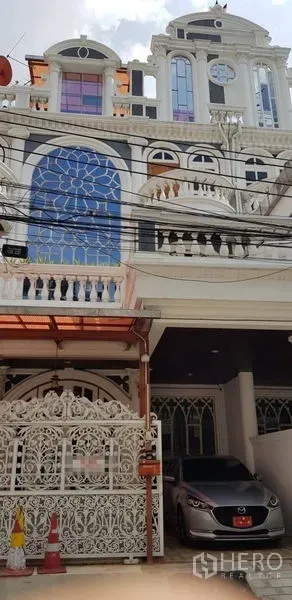 Home Office for rent in Watthana, Bangkok - Ornate white multi-storey townhouse facade with gated carport near BTS Ekkamai.
