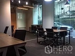 Office Space for rent in Khlong Toei, Bangkok - Conference table and chairs beside a glass façade within a contemporary office interior.