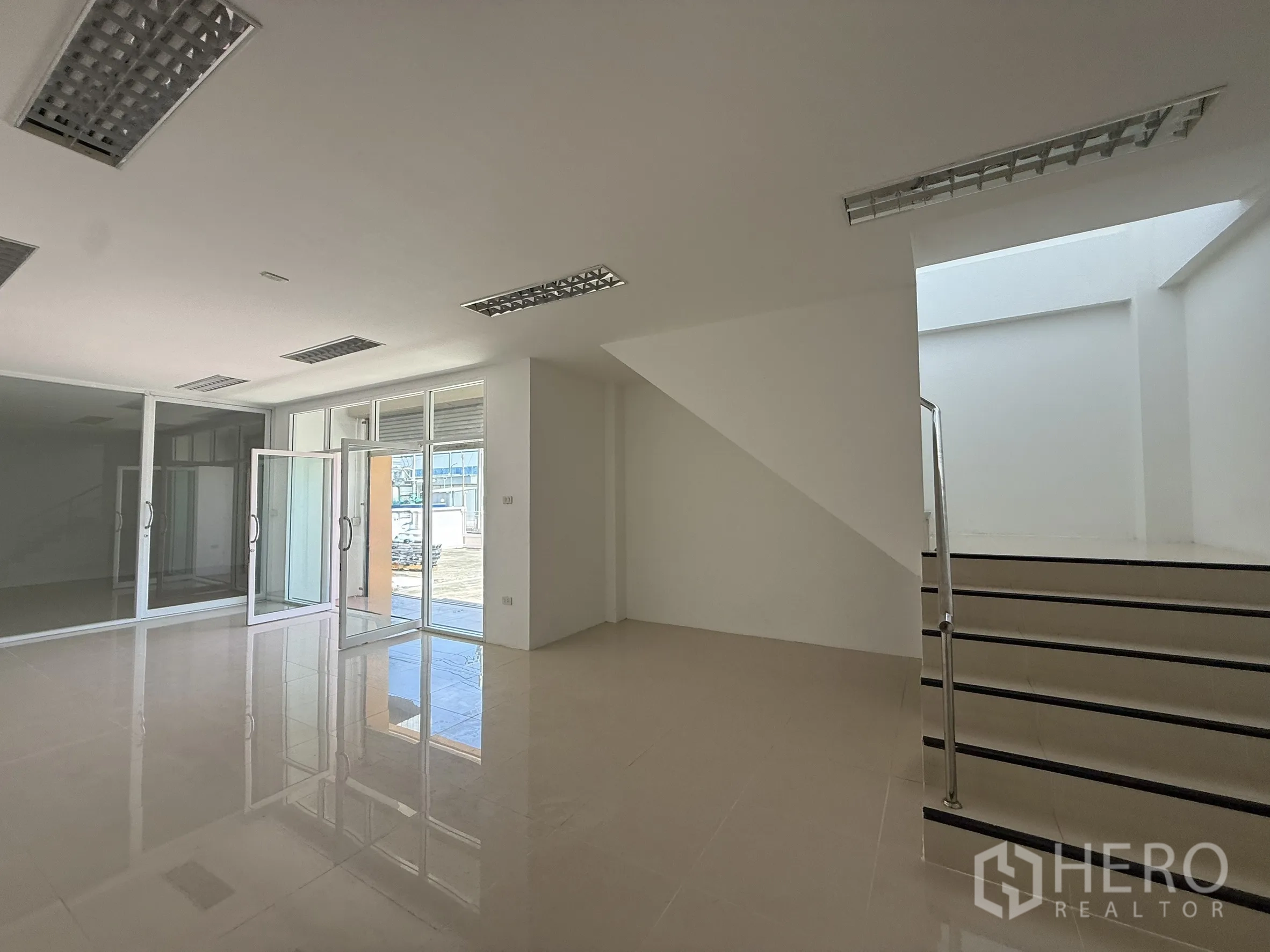 Warehouse for rent or sale in Bang Bo, Samut Prakan - Bright ground‑floor office lobby with glass frontage and stairway.