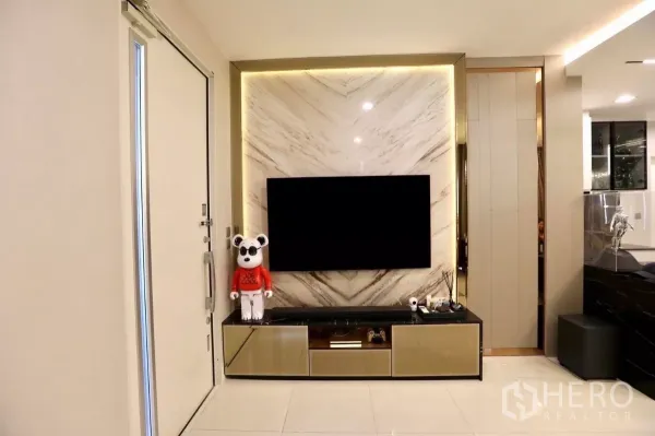 Detached House for rent in Samut Prakan - Bright lounge with marble feature TV wall and built-in low cabinet.