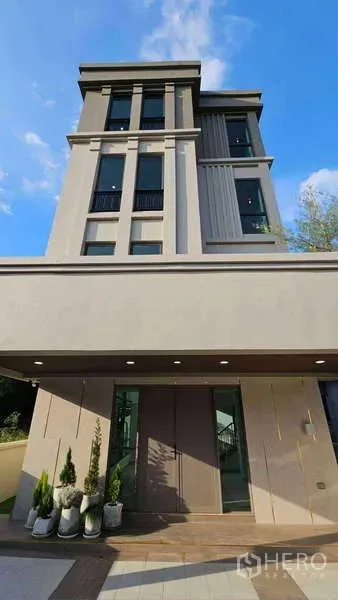 Detached House for rent or sale in Suan Luang, Bangkok - Street-level view of the detached house exterior with vertical lines and large windows