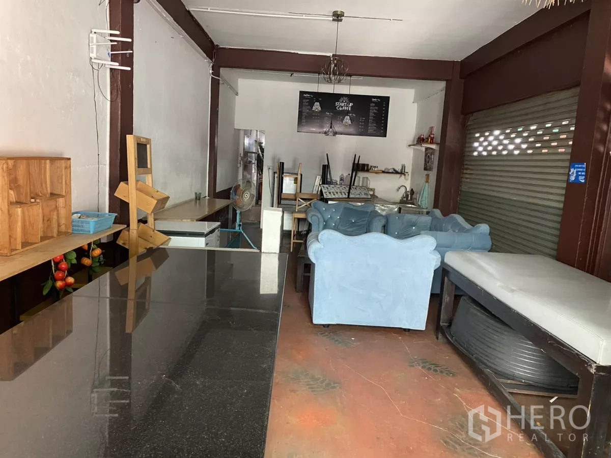 店屋 出租在Khlong Toei, Bangkok - 前部营业大厅，长吧台、休息区与卷帘门。