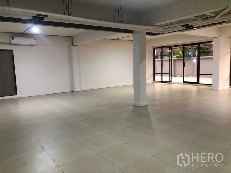 办公空间 出租在Phaya Thai, Bangkok - 开放办公楼层，立柱、多个空调与推拉玻璃门。