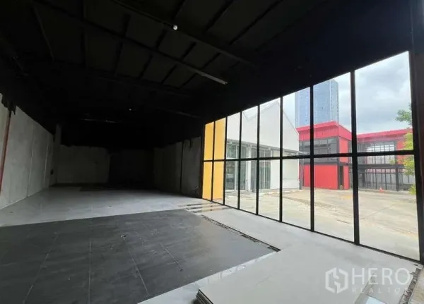 Retail Space for rent in Bang Na, Bangkok - Spacious shop unit with floor-to-ceiling windows overlooking a modern commercial courtyard.