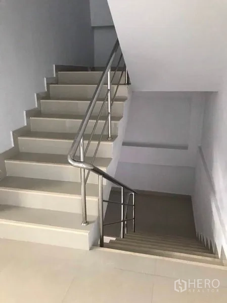 Factory for rent or sale in Mueang Samut Sakhon, Samut Sakhon - Interior stairwell with tiled steps and stainless-steel handrails.