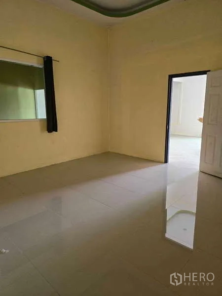 Warehouse for rent in Khlong Sam Wa, Bangkok - Tiled office room with interior window and doorway to a brighter workspace.