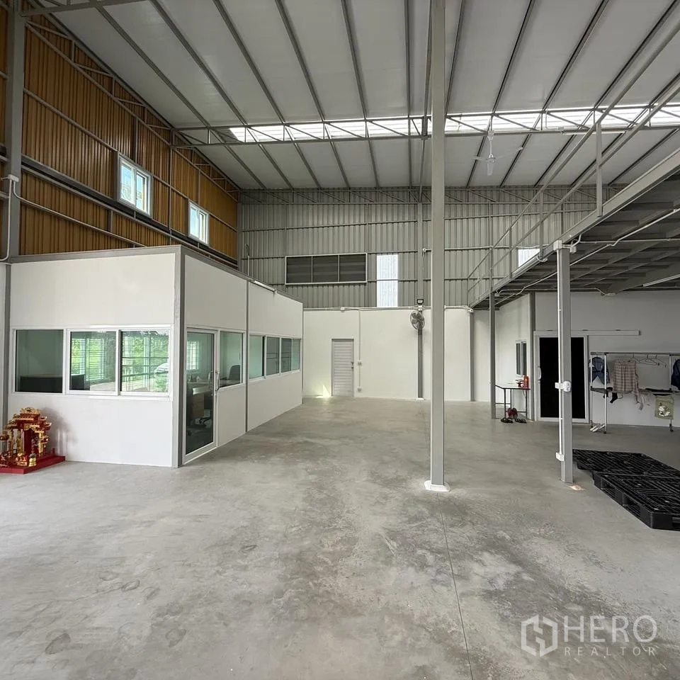 仓库 for rent or sale in Khlong Luang, Pathum Thani - 仓库内部挑高，设隔断办公室与混凝土地面。