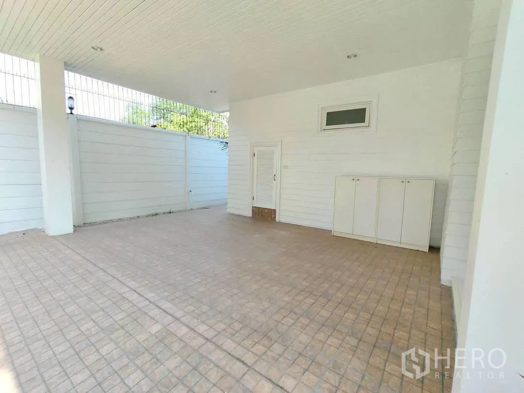 Detached House for rent in Bang Na, Bangkok - Covered carport with tiled floor and storage cabinets.