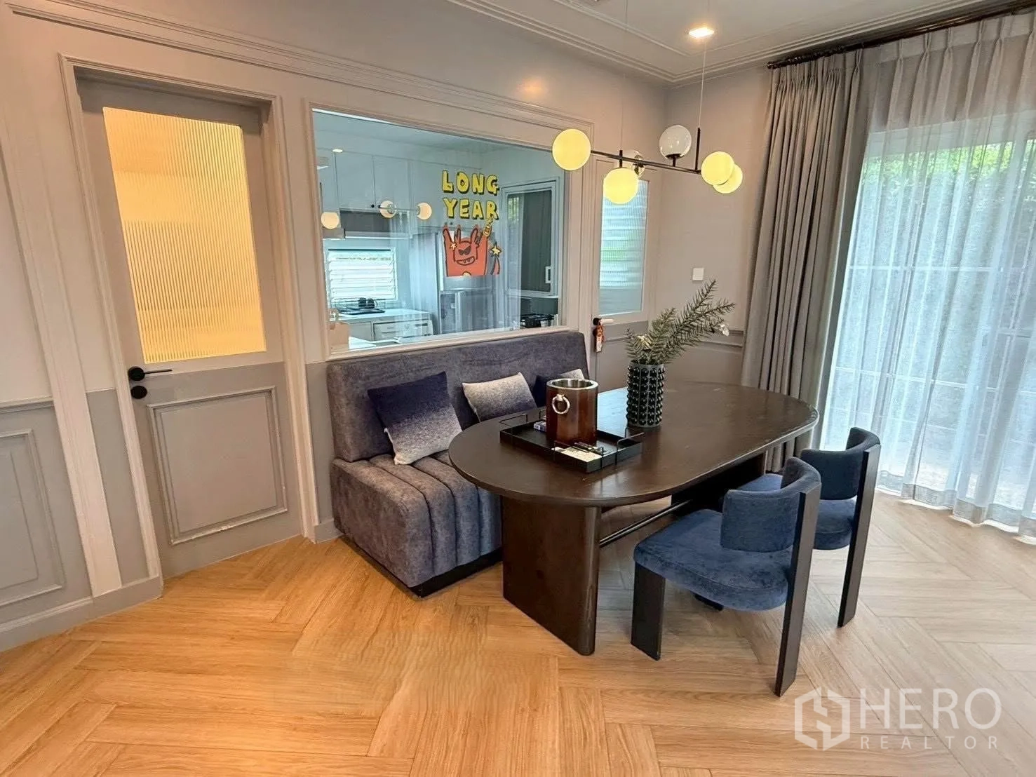 Detached House for rent in Bang Phli, Samut Prakan - Stylish dining area with sofa bench, pendant light, and sheer curtains.