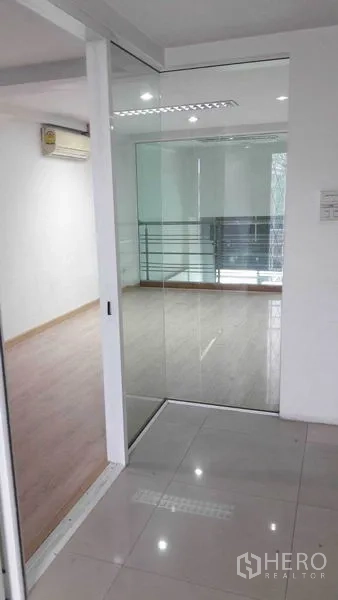 Office Space for rent in Bueng Kum, Bangkok - Entrance to a glass-partitioned meeting room with a sliding door.