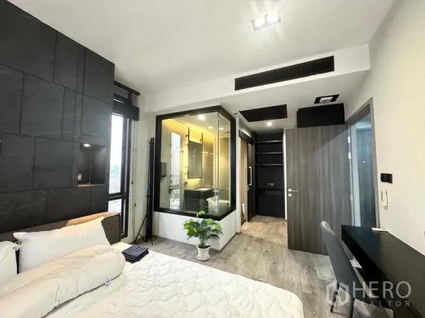 Condominium for rent - Master bedroom with a glass-enclosed bathroom, built-in wardrobe and a work desk.