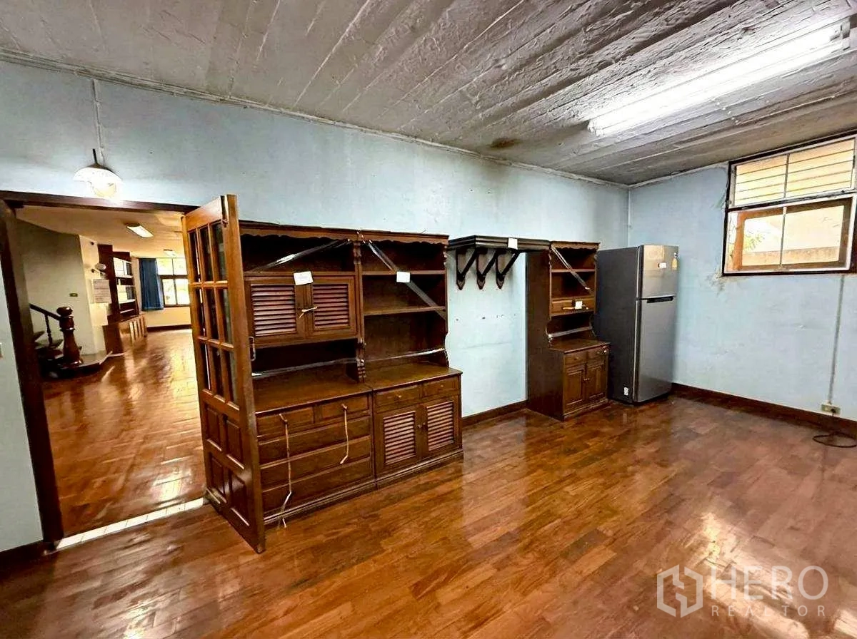 Home Office for rent in Bang Rak, Bangkok - Room featuring wooden built-in cabinetry and a refrigerator.