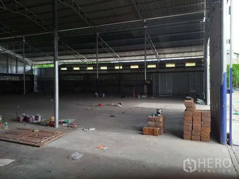 Warehouse for rent in Pak Kret, Nonthaburi - Spacious warehouse interior showing high steel truss roof and open clear-span floor.