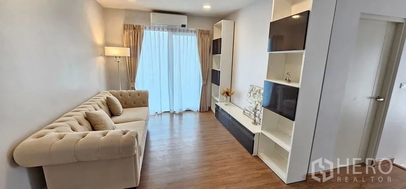 Detached House for rent - Upstairs family room with beige sectional sofa, built-in media shelves and a sliding glass door.
