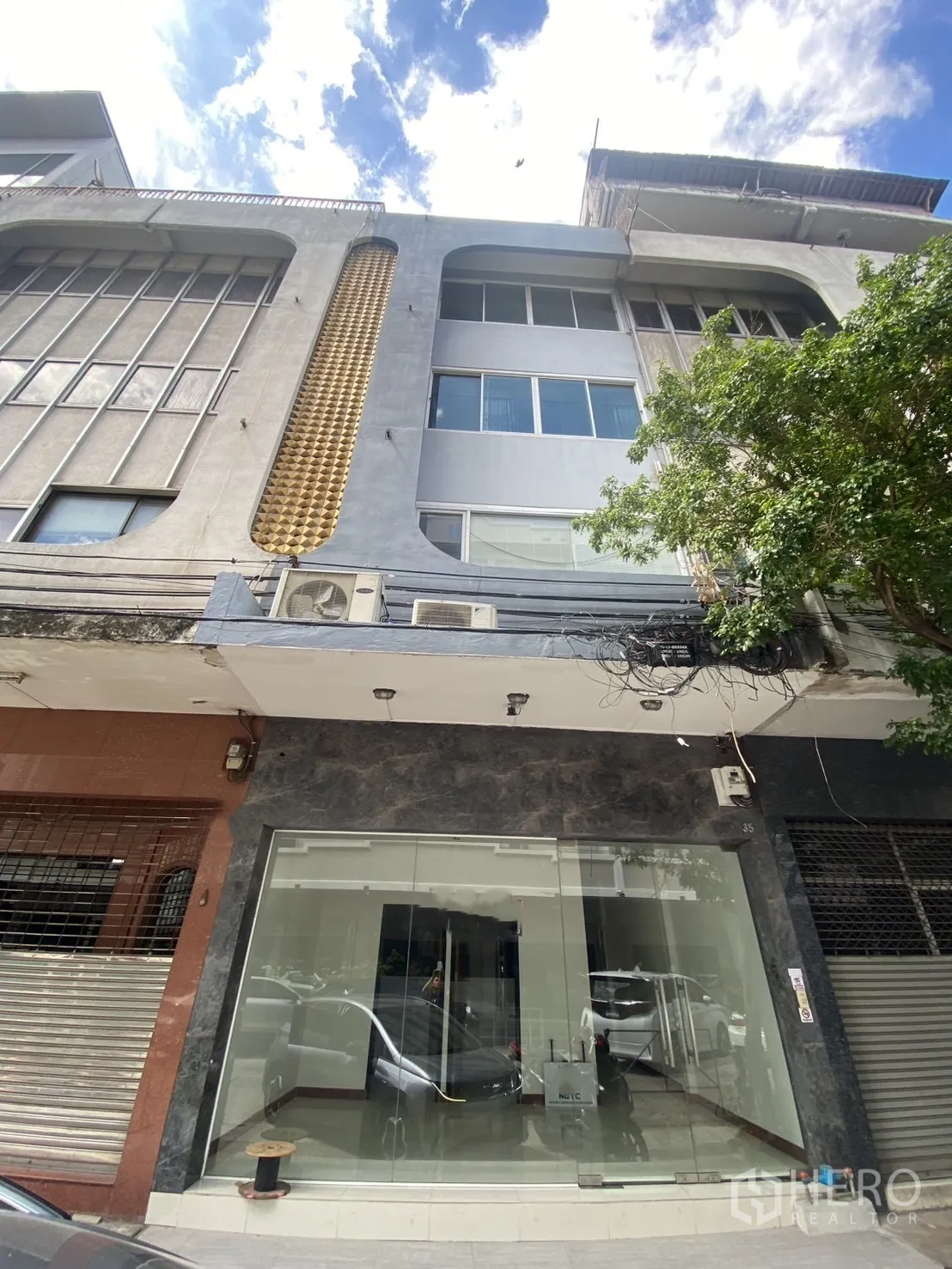 Shophouse for rent in Bang Rak, Bangkok - Full facade of the multi‑storey shophouse with gold accent panel and large windows.