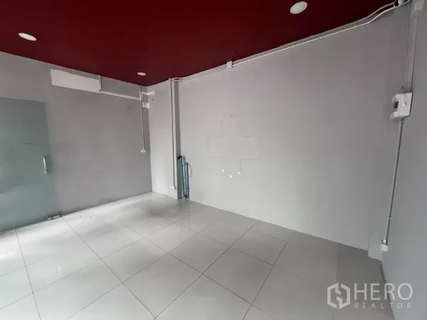 Retail Space for rent in Watthana, Bangkok - Bright shop interior with glossy tiles, grey walls and a clear glass door.