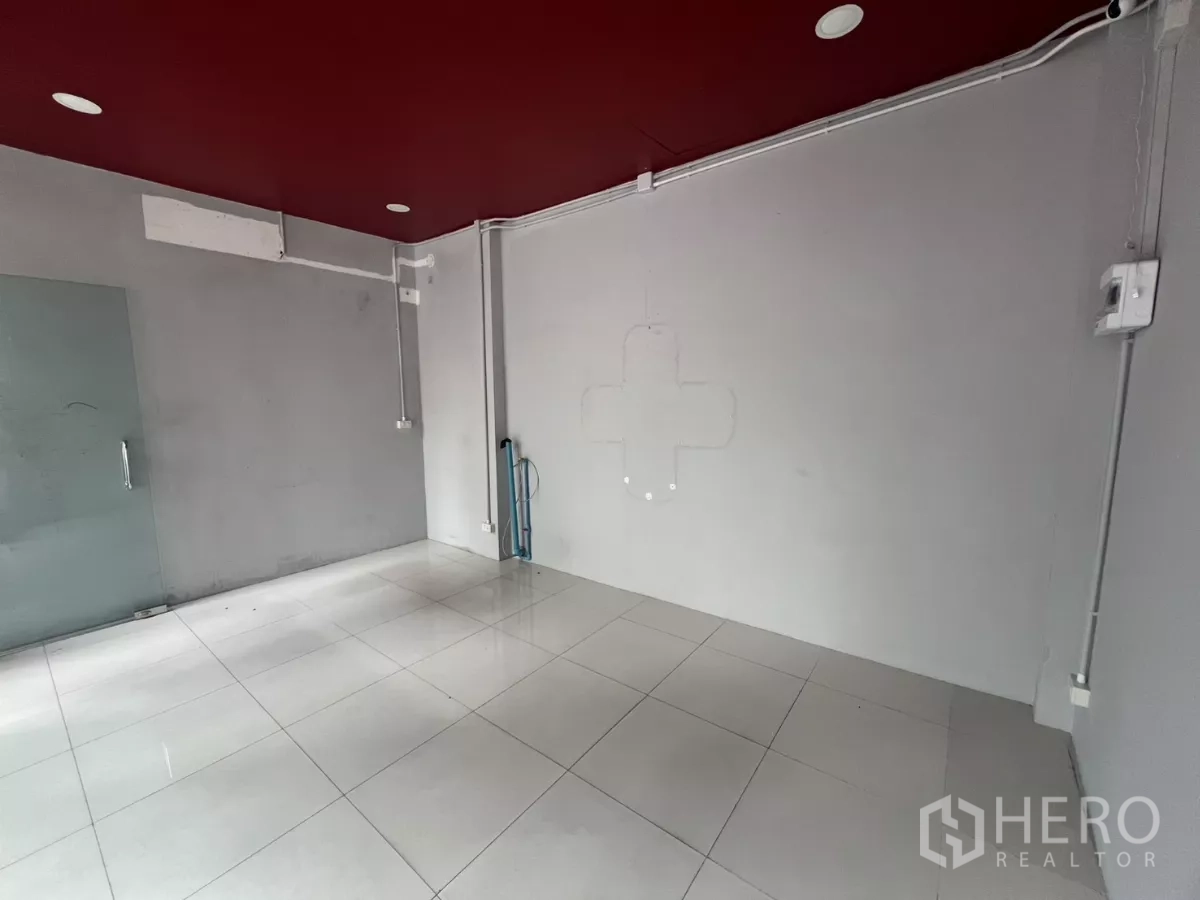 Retail Space for rent in Watthana, Bangkok - Bright shop interior with glossy tiles, grey walls and a clear glass door.