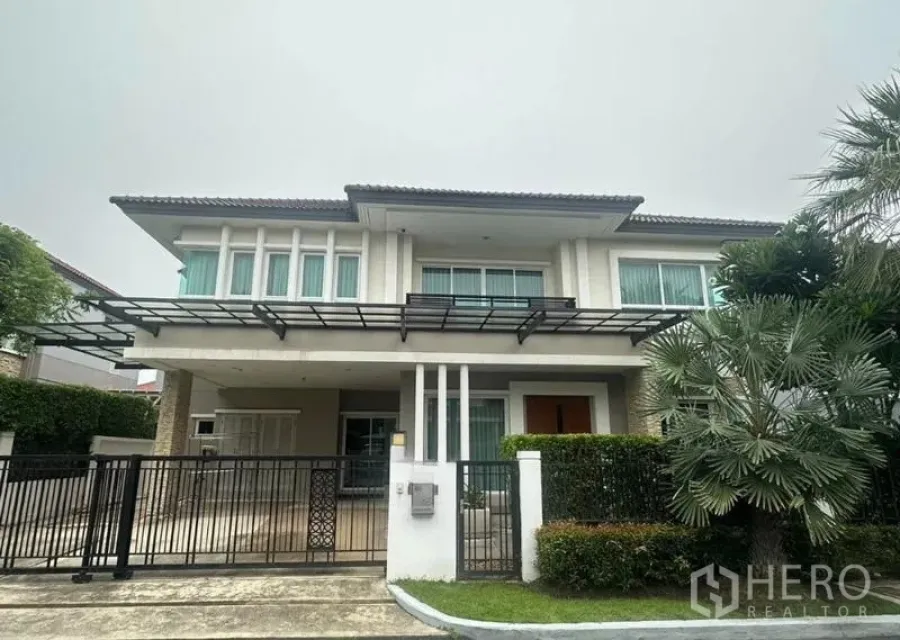 Detached House for sale in Saphan Sung, Bangkok - Front elevation of a modern two-storey house with metal gate and carport.