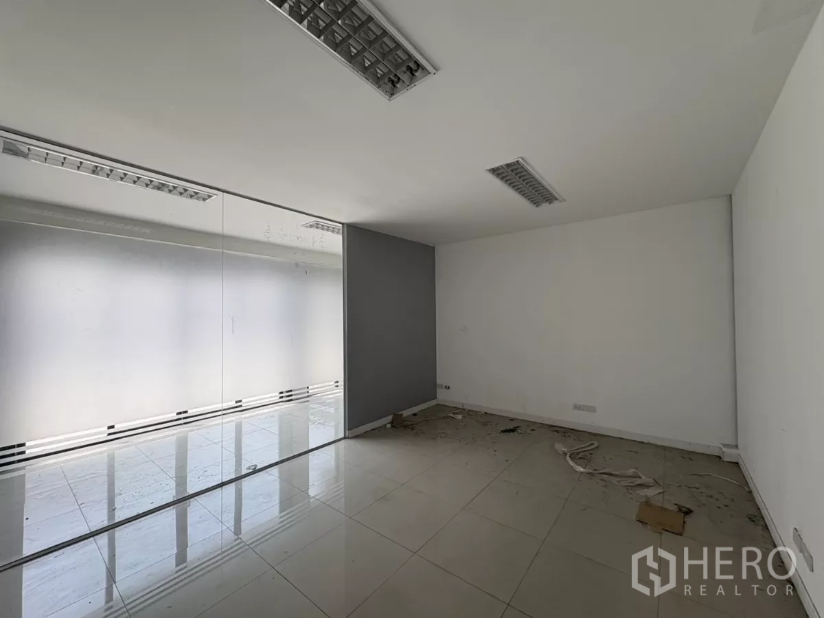 Warehouse for rent in Bang Phli, Samut Prakan - Office room with frosted glass partition and tiled flooring.