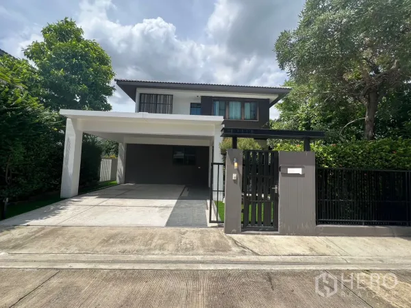 Detached House for rent in Bang Phli, Samut Prakan - Modern two-storey detached house with gated entrance and covered two-car carport.