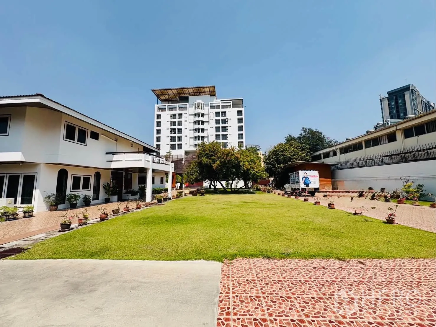 Home Office for rent in Bang Na, Bangkok - Expansive central lawn flanked by low-rise buildings and paved walkways.