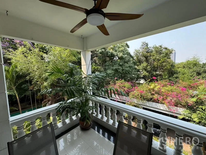 Condominium for rent in Yan Nawa, Bangkok - Corner balcony with ceiling fan, potted plant and garden view.