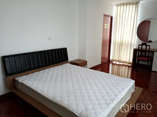 อพาร์ทเมนท์ ให้เช่าในWatthana, Bangkok - ห้องนอนกว้าง เตียงควีนไซส์ โต๊ะข้างโต๊ะเครื่องแป้ง และผ้าม่านโปร่ง