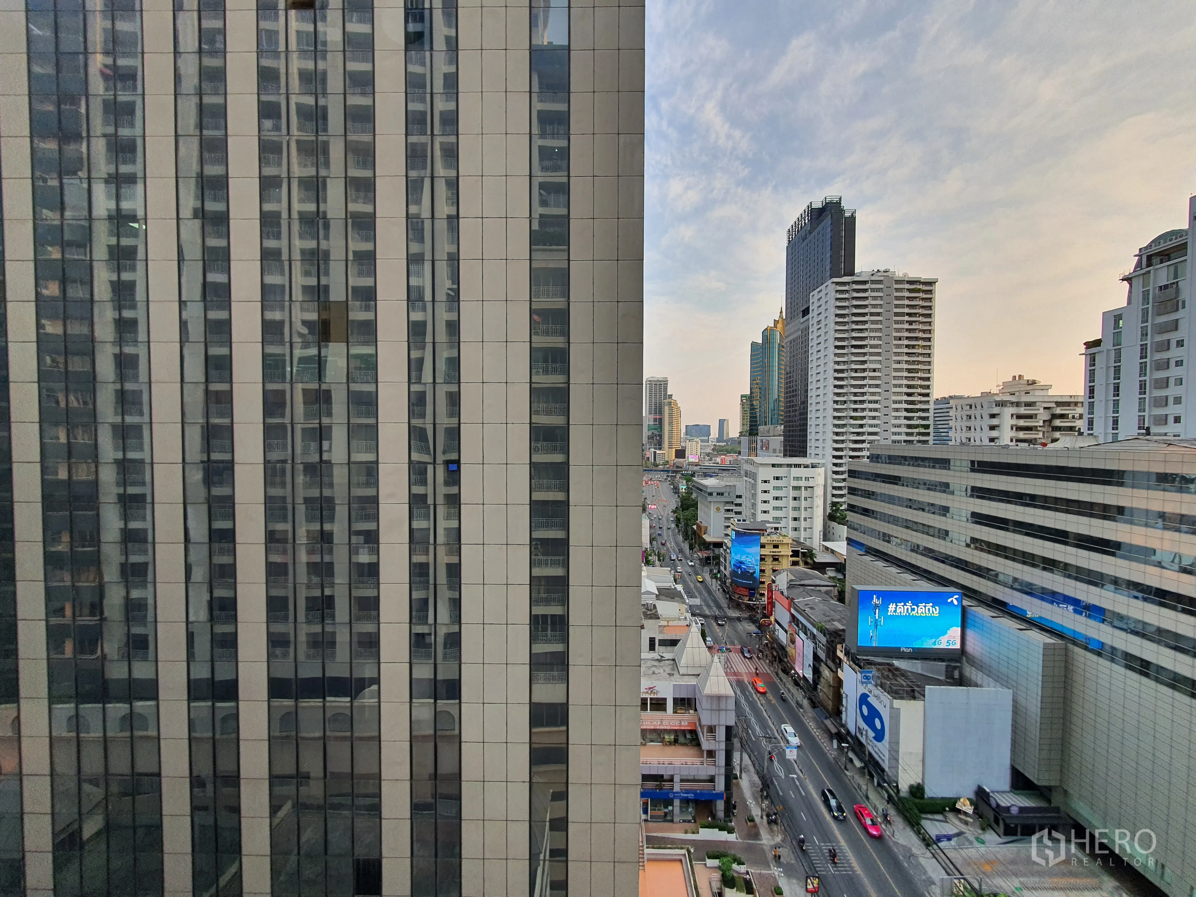 Condominium for rent in Watthana, Bangkok - Urban skyline and busy road viewed between tall office towers.