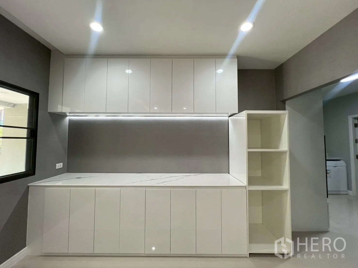 Detached House for rent or sale in Bang Phli, Samut Prakan - Minimal white kitchen with marble-look countertop and ample cabinets.