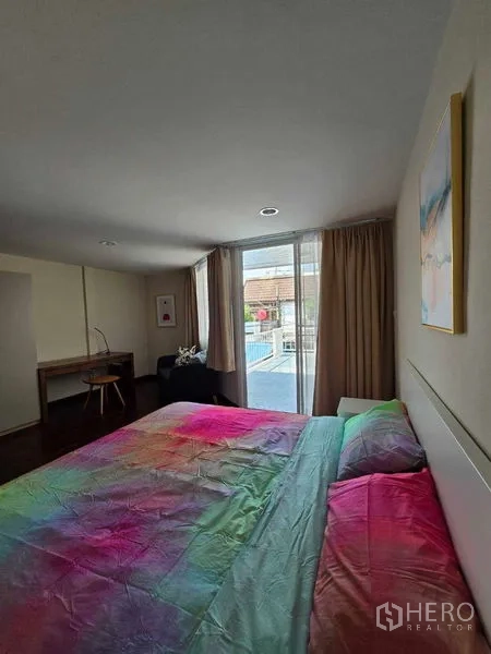 ทาวน์เฮาส์ ให้เช่าในBang Na, Bangkok - เตียงนอนหันสู่ประตูกระจกบานเลื่อนออกสู่ระเบียงเล็ก พร้อมผ้าม่านทึบ