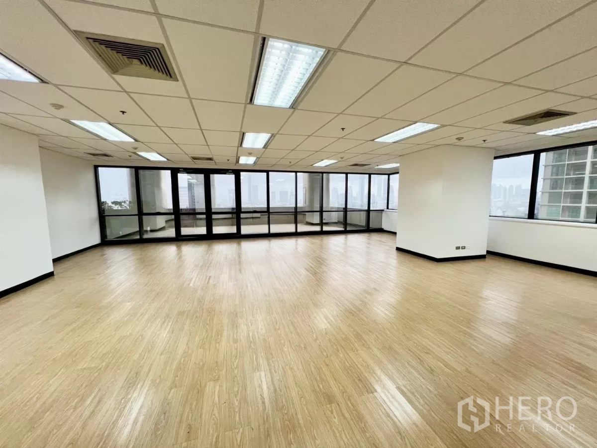 Office Space for rent in Huai Khwang, Bangkok - Open corner office with wraparound windows, glass doors and skyline views across Bangkok.