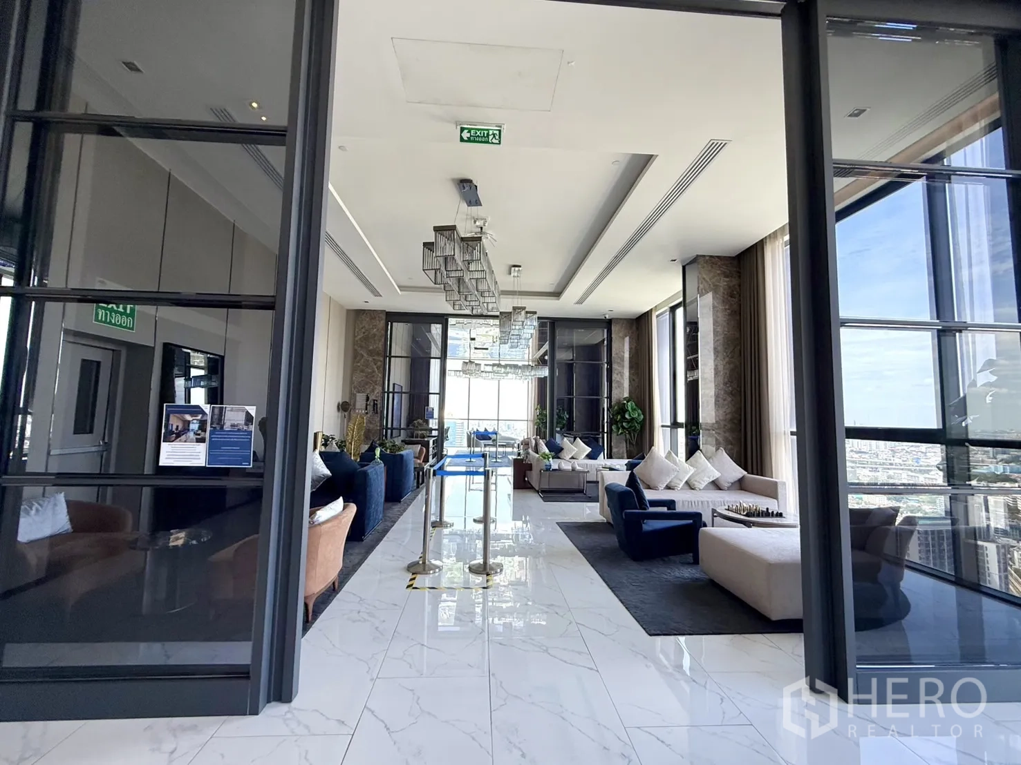 Condominium for sale in Chatuchak, Bangkok - Elegant lobby lounge with floor-to-ceiling windows and sofas.