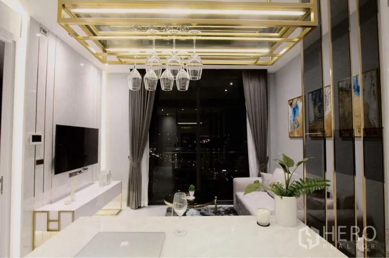 Condominium for rent in Bangkok - Contemporary living area with pendant wine-glass rack, sofa and large window city view.