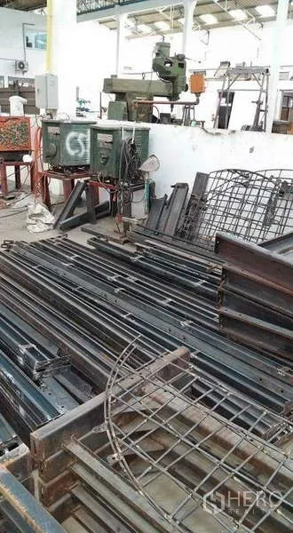 Warehouse for rent or sale in Nong Suea, Pathum Thani - Piles of steel bars and mesh stored in a warehouse bay.
