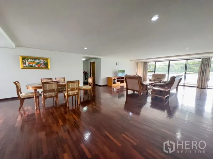 Condominium for sale in Samut Prakan - Expansive open-plan living and dining space with floor-to-ceiling windows leading to the balcony.