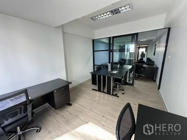 Office Space for rent in Watthana, Bangkok - Bright office zone with black-framed glass partitions separating a meeting room and manager desk.