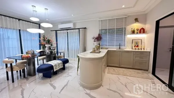 Detached House for rent or sale - Bright dining and island kitchen with marble-look flooring, pendant lights and sheer curtains.