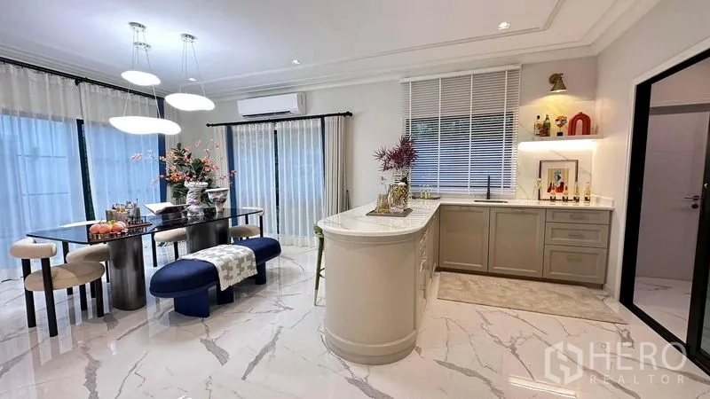 Detached House for rent or sale - Bright dining and island kitchen with marble-look flooring, pendant lights and sheer curtains.