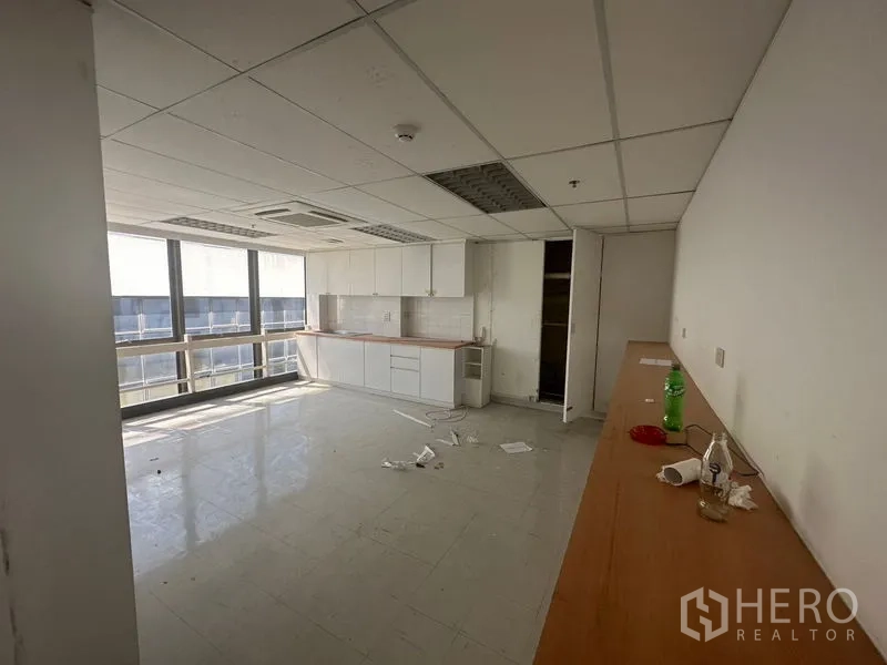 Office Space for rent in Khlong Toei, Bangkok - Pantry area with built-in white cabinets, long countertop and wide windows.