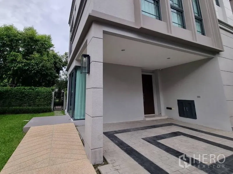 Detached House for rent - Covered carport and entrance porch beside a green lawn and hedge.