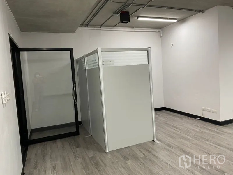 Office Space for rent - Glass entry door and modular partition creating a meeting room within the office space.