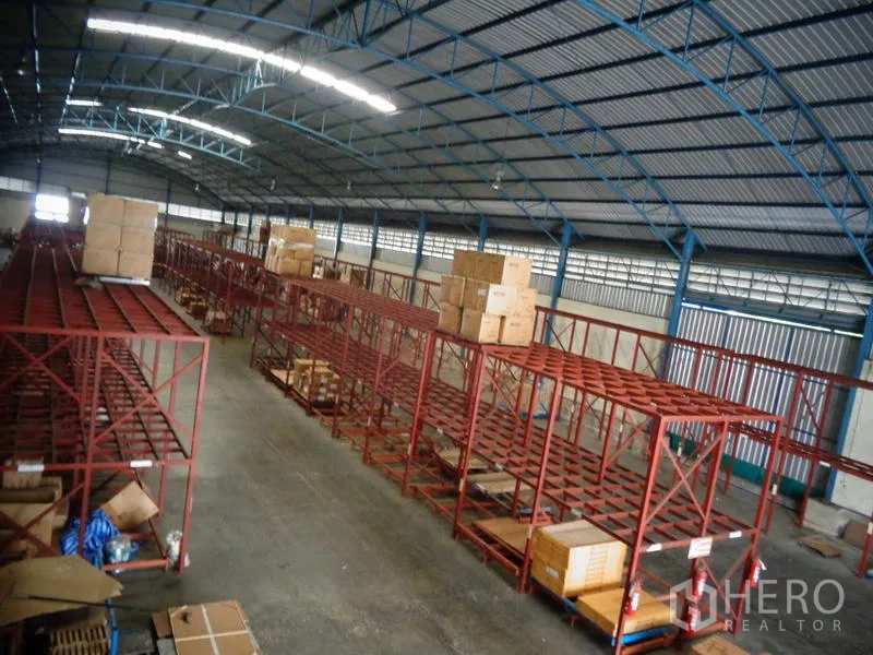 Warehouse for rent or sale in Lat Lum Kaeo, Pathum Thani - Overhead shot of storage aisles with boxes on top racks and wide floor space.