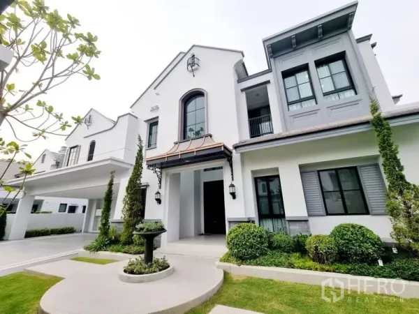 Detached House for rent in Saphan Sung, Bangkok - Modern classic house facade with manicured garden, fountain, and covered parking.