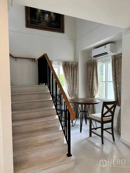 Detached House for sale in Bang Phli, Samut Prakan - Staircase with black handrail and small sitting nook by the window