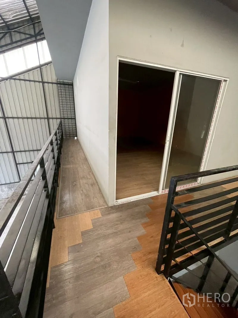 Warehouse for rent in Lat Phrao, Bangkok - Mezzanine walkway with metal railing and a sliding glass door to the office.