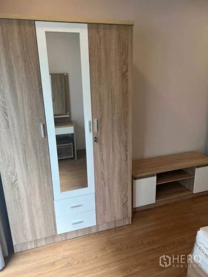 Detached House for rent in Bang Phli, Samut Prakan - Wood-textured wardrobe with central mirror and matching low cabinet.