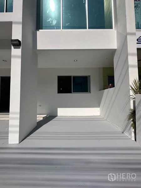 Home Office for sale in Lat Krabang, Bangkok - Covered carport area beneath the building with window and recessed lighting.