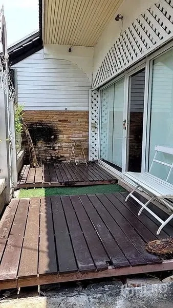 Detached House for rent - Front wooden deck with sliding glass doors and white lattice facade.